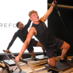 Men on a refomer machine in a Reformercore studio