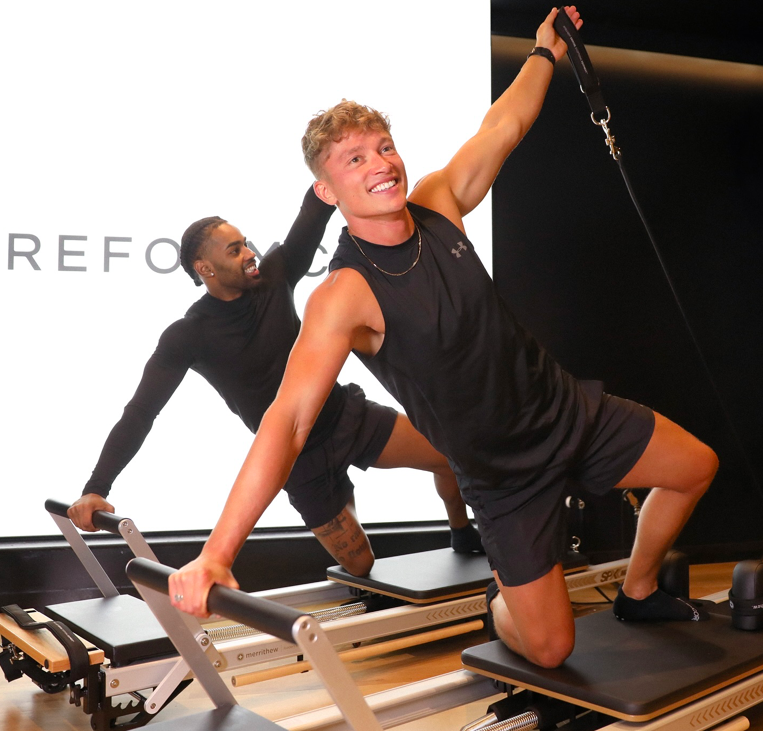 Men on a refomer machine in a Reformercore studio